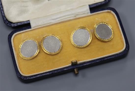 A cased pair of engine turned 18ct gold and platinum circular cufflinks, gross 8.2 grams.